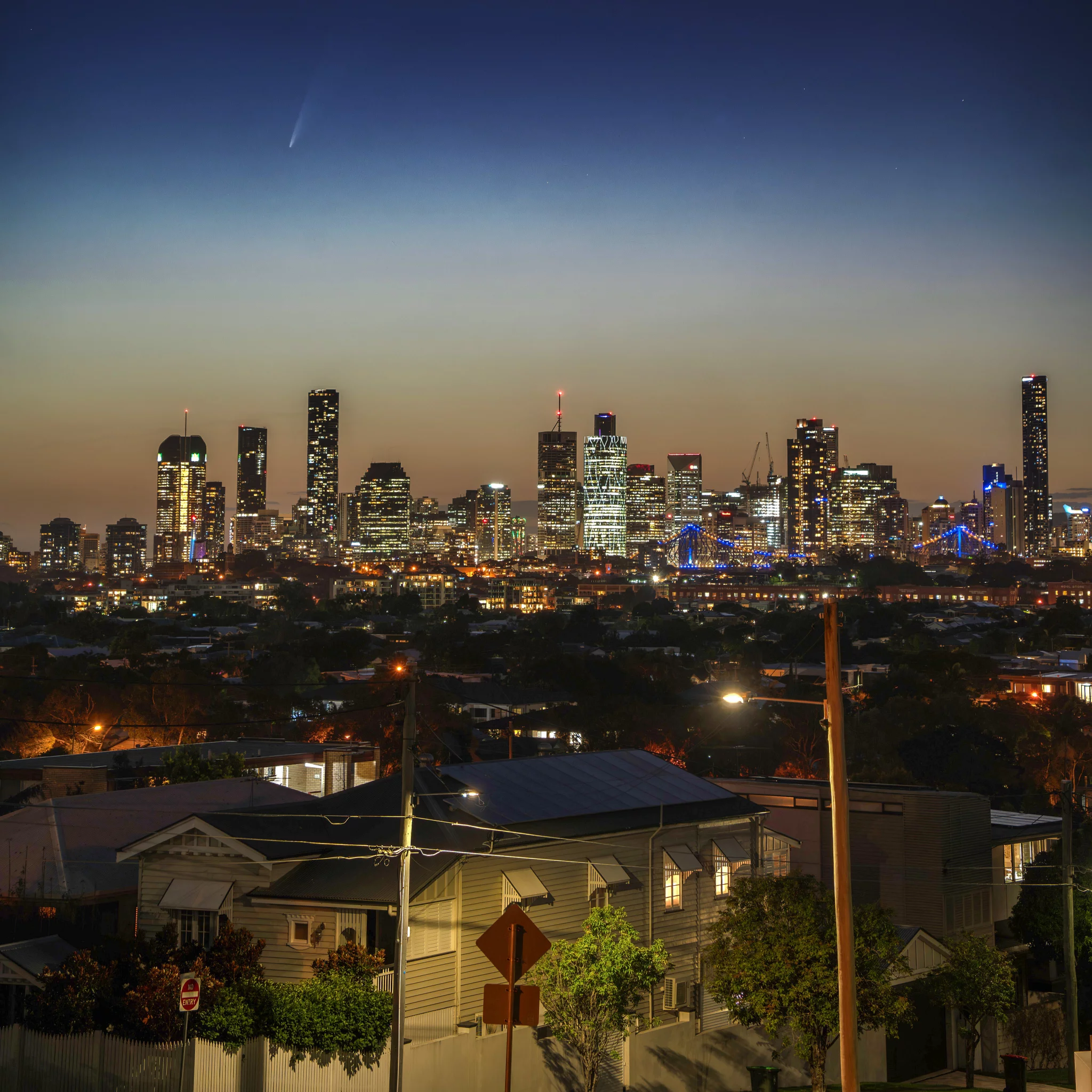 Comet over city skyline from Bortle 8 skies